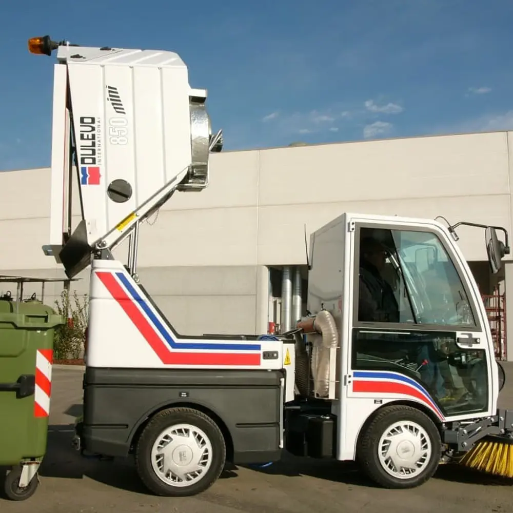 Dulevo 850 veegwagen lost verzameld vuil in groene afvalcontainer